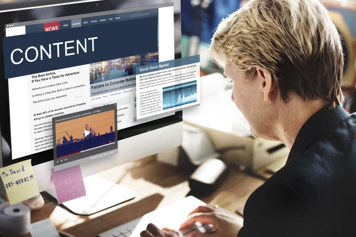 women in front of computer showing website with drupal